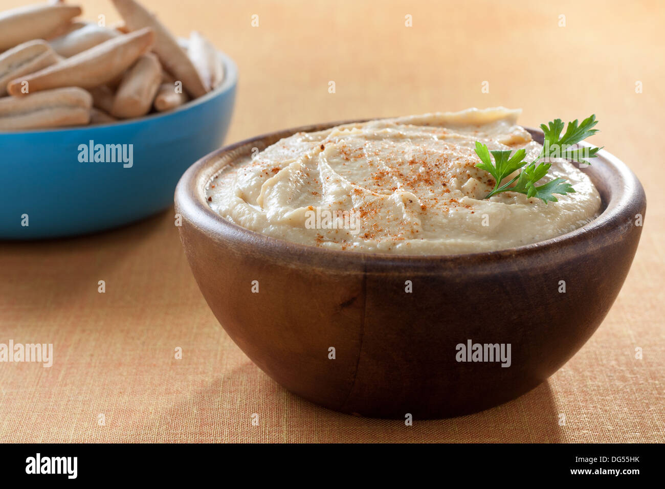 Ciotola di hummus con prezzemolo e grissini Foto Stock