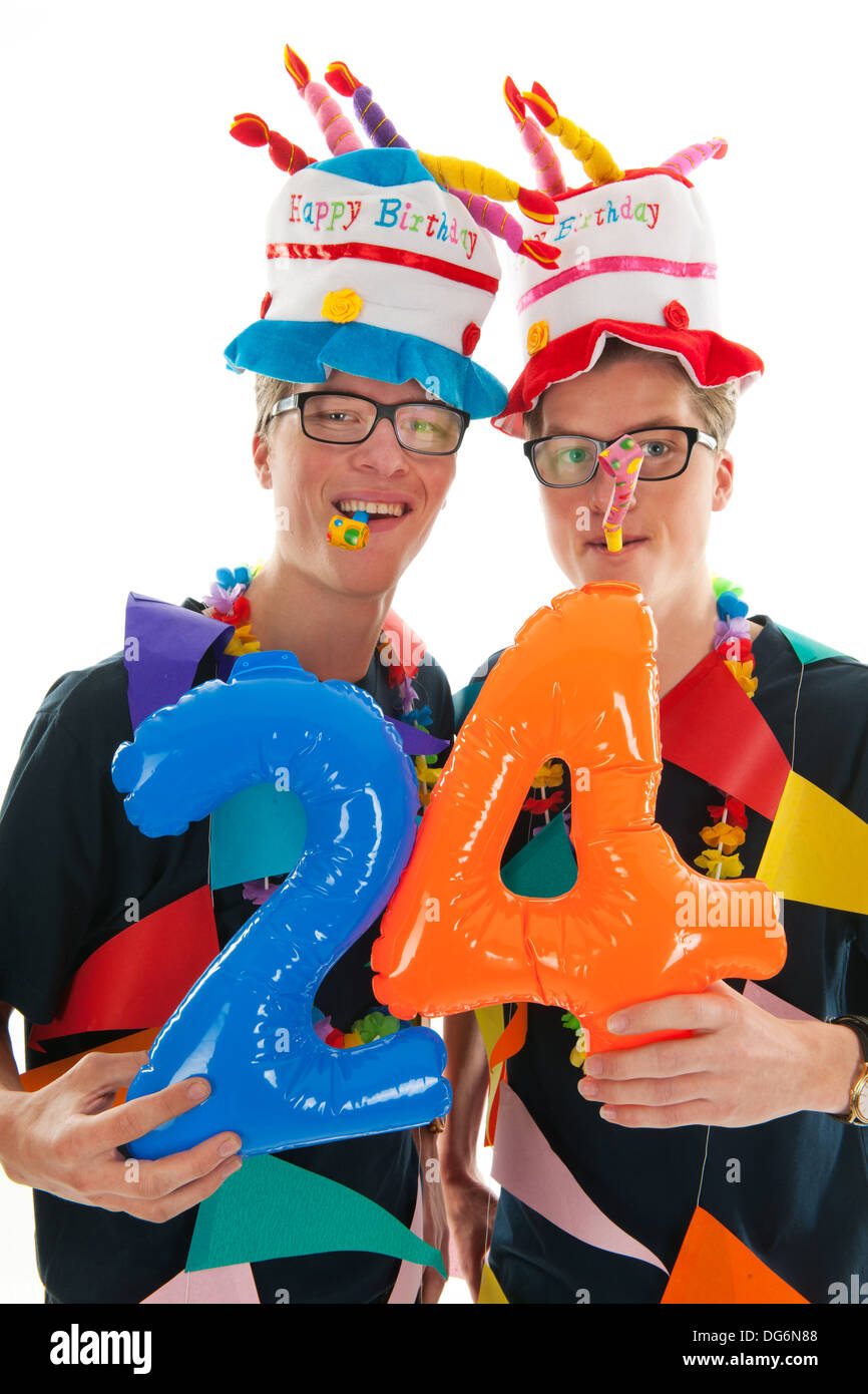 Identicamente maschio adulto gemelli avente il compleanno in studio Foto Stock
