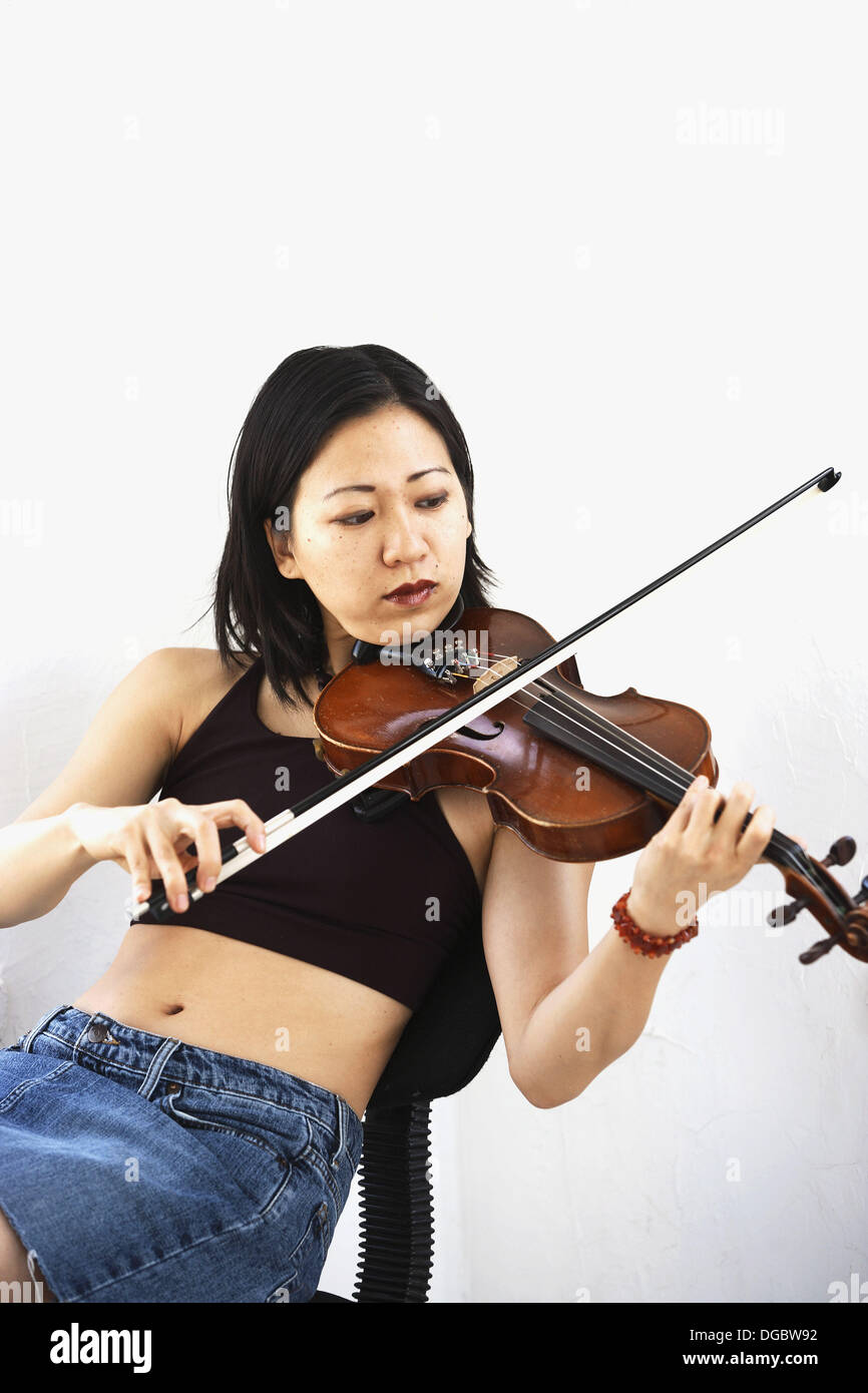 Asian/cinese donna seduta suona il violino Foto stock - Alamy