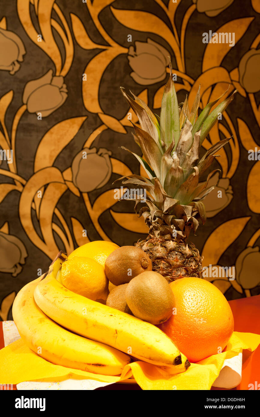 Frutta sul desk composition, banane, ananas, kiwi Foto Stock