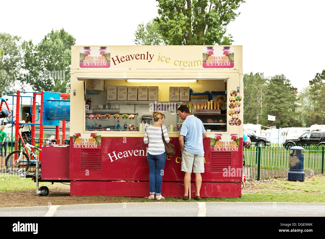 Giovane acquisto di gelato nei pressi di un parco giochi per bambini a Northampton, Inghilterra Foto Stock