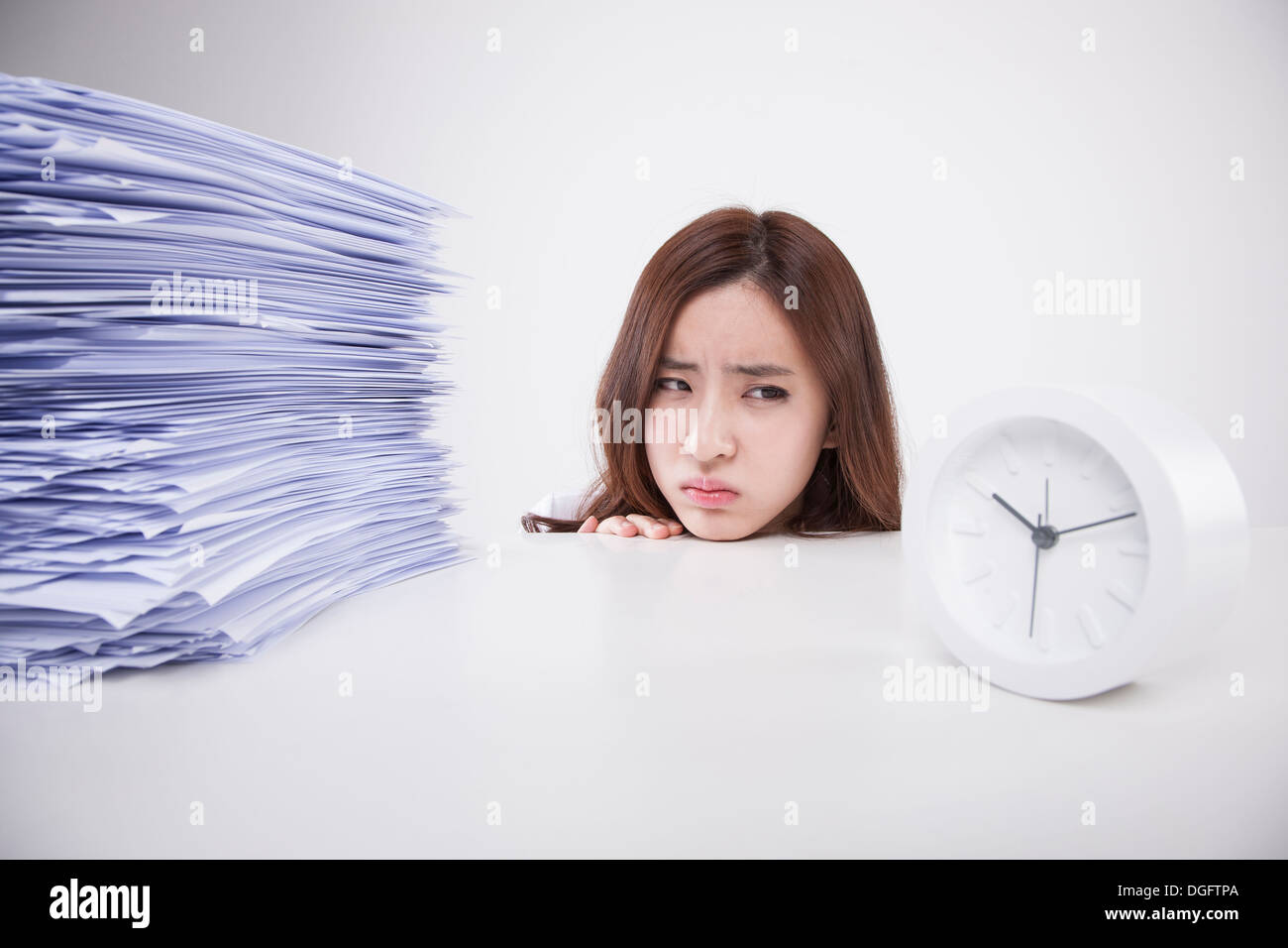 Una donna di affari con una grande pila di lavoro Foto Stock