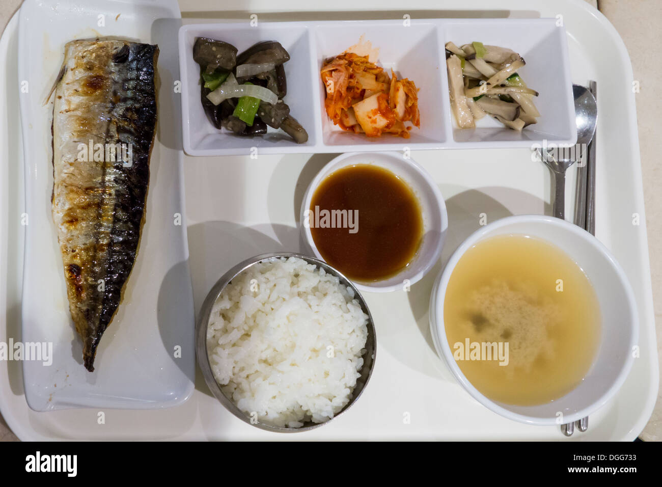 Tipico self service menu semplice (grigliate di pesce, ciotola di riso e zuppa con una selezione di contorni) sul vassoio, Corea Foto Stock