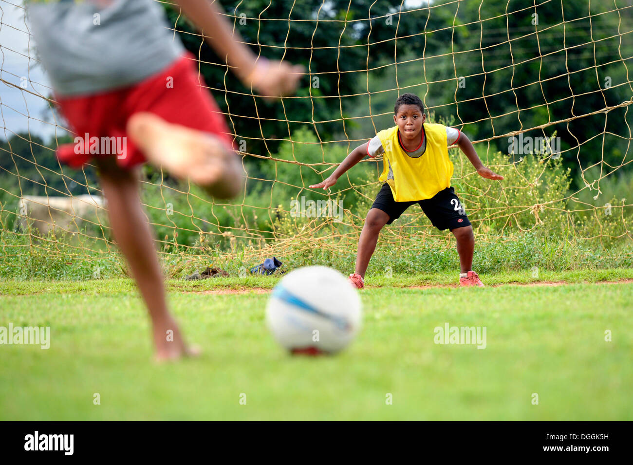 Il portiere concentrandosi sulla sfera durante un calcio di rigore, progetto sociale in una favela, Poxoréo, Mato Grosso, Brasile Foto Stock