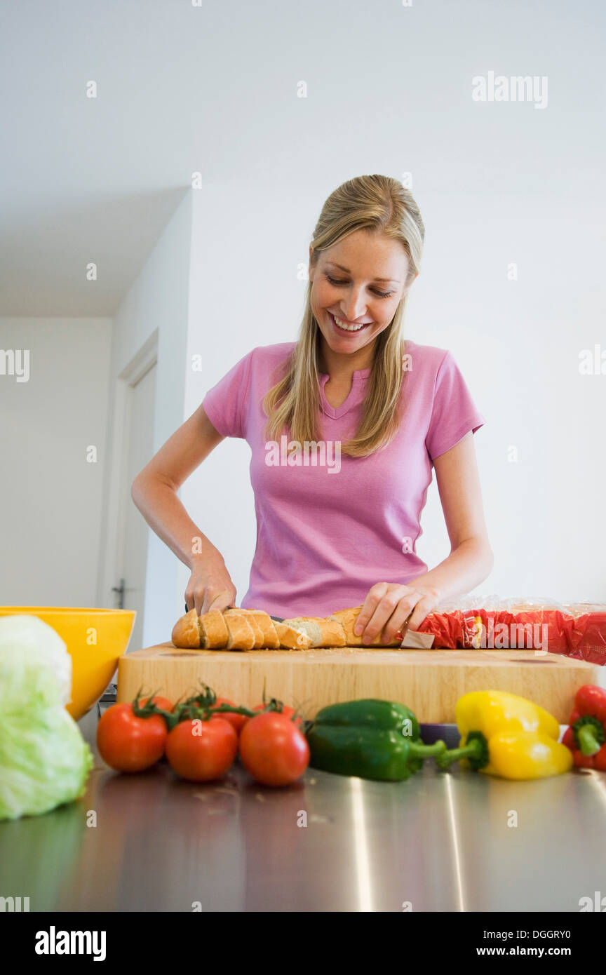 Giovane donna la preparazione di alimenti Foto Stock