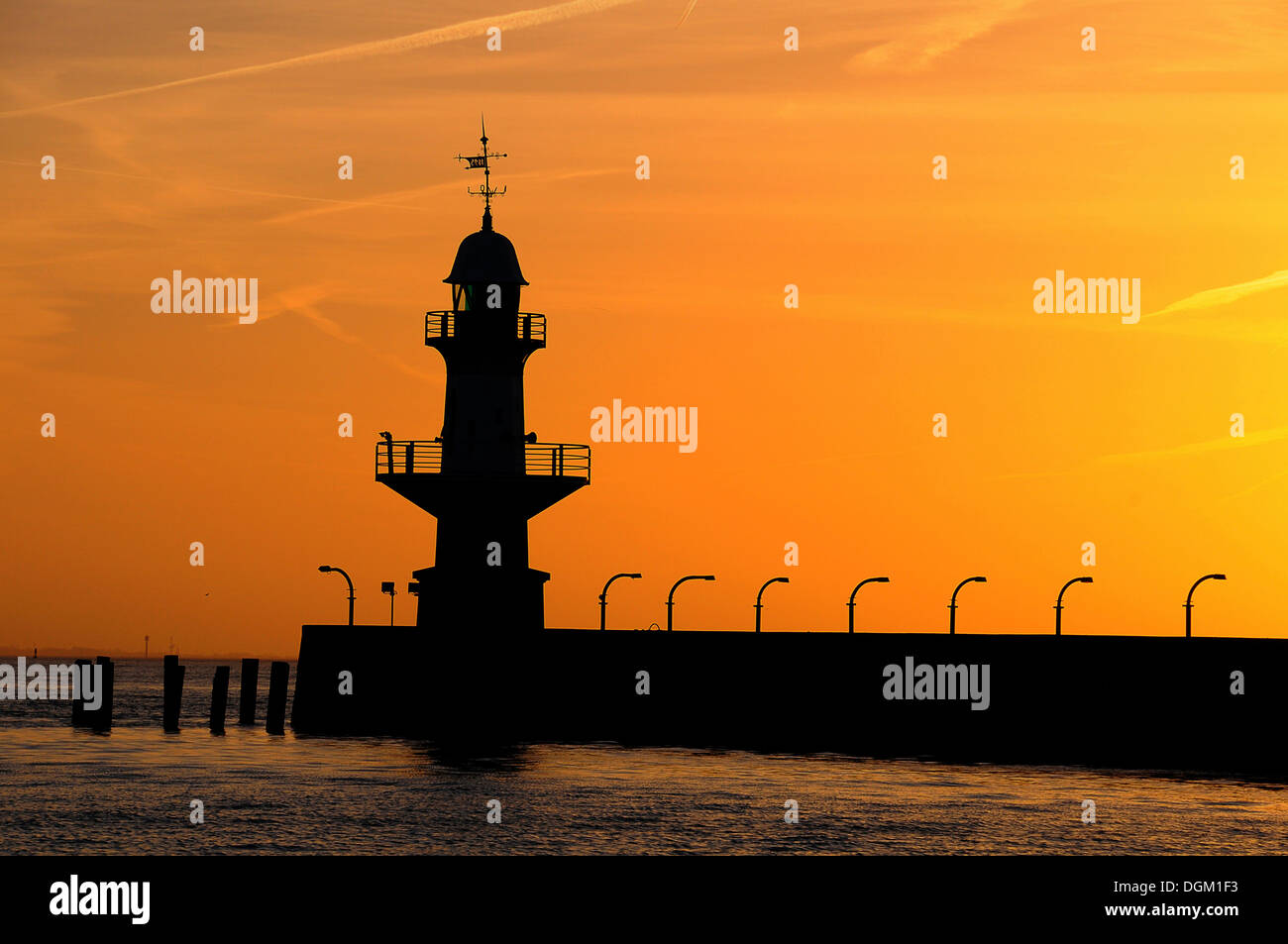 Silhouette di Brunsbuettel mole 1 faro anteriore di un cielo di sera, Brunsbüttel, Schleswig-Holstein, Germania Foto Stock