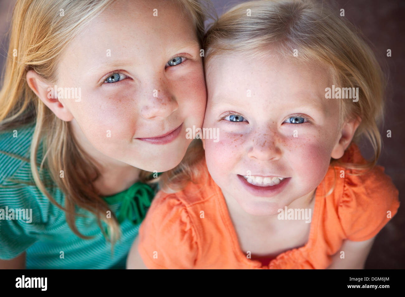 Un ritratto di due sorelle sorridente. Due giovani ragazze, con occhi blu e capelli biondi. Foto Stock