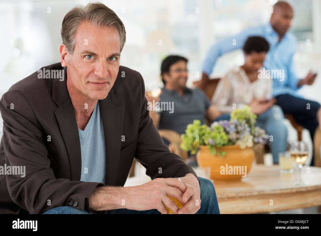 Evento di Office. Un uomo seduto lontano dal gruppo. Foto Stock