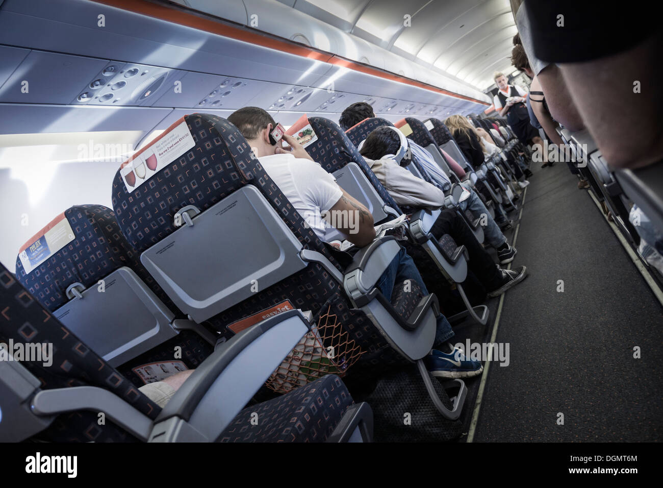 A bordo di un volo EasyJet, legato per la Spagna, che mostra l'assistente di volo a piedi la corsia. Foto Stock
