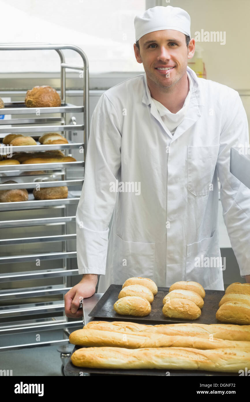 Giovane maschio baker in piedi in una cucina Foto Stock
