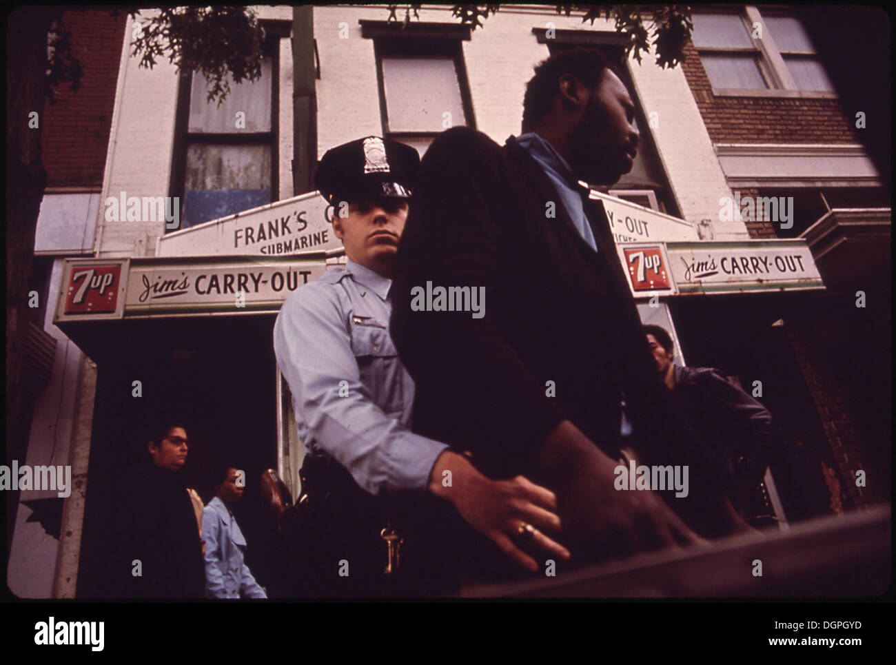 Questa immagine cattura un arresto di strada in corso, mostrando che gli agenti delle forze dell'ordine arrestano un individuo. La scena illustra un momento tipico delle azioni delle forze dell'ordine pubbliche. Foto Stock