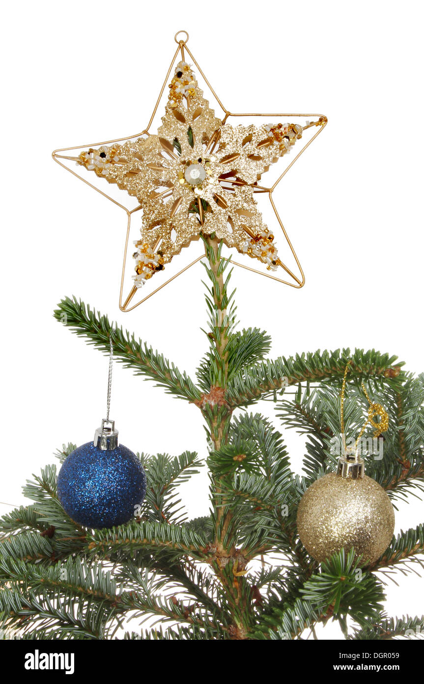 Stella d'oro e baubles in un albero di Natale Foto Stock