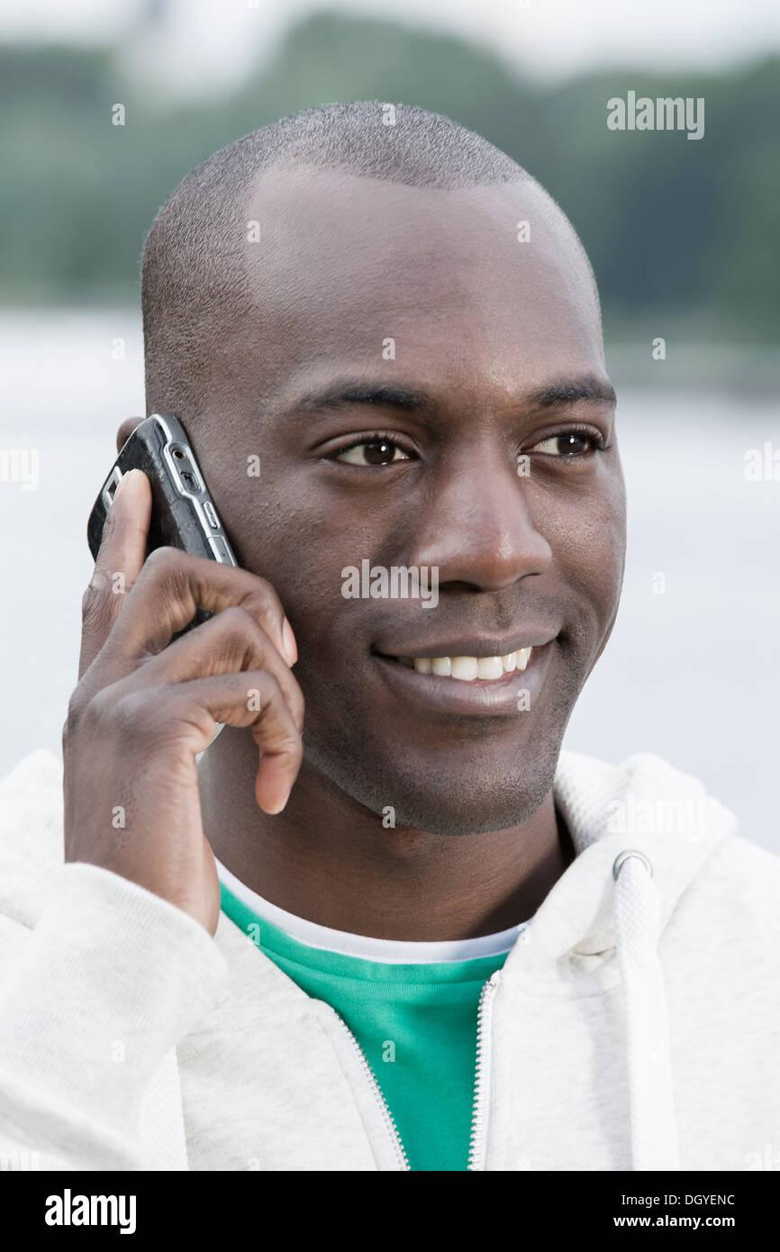 Uomo sorridente sul telefono Foto Stock