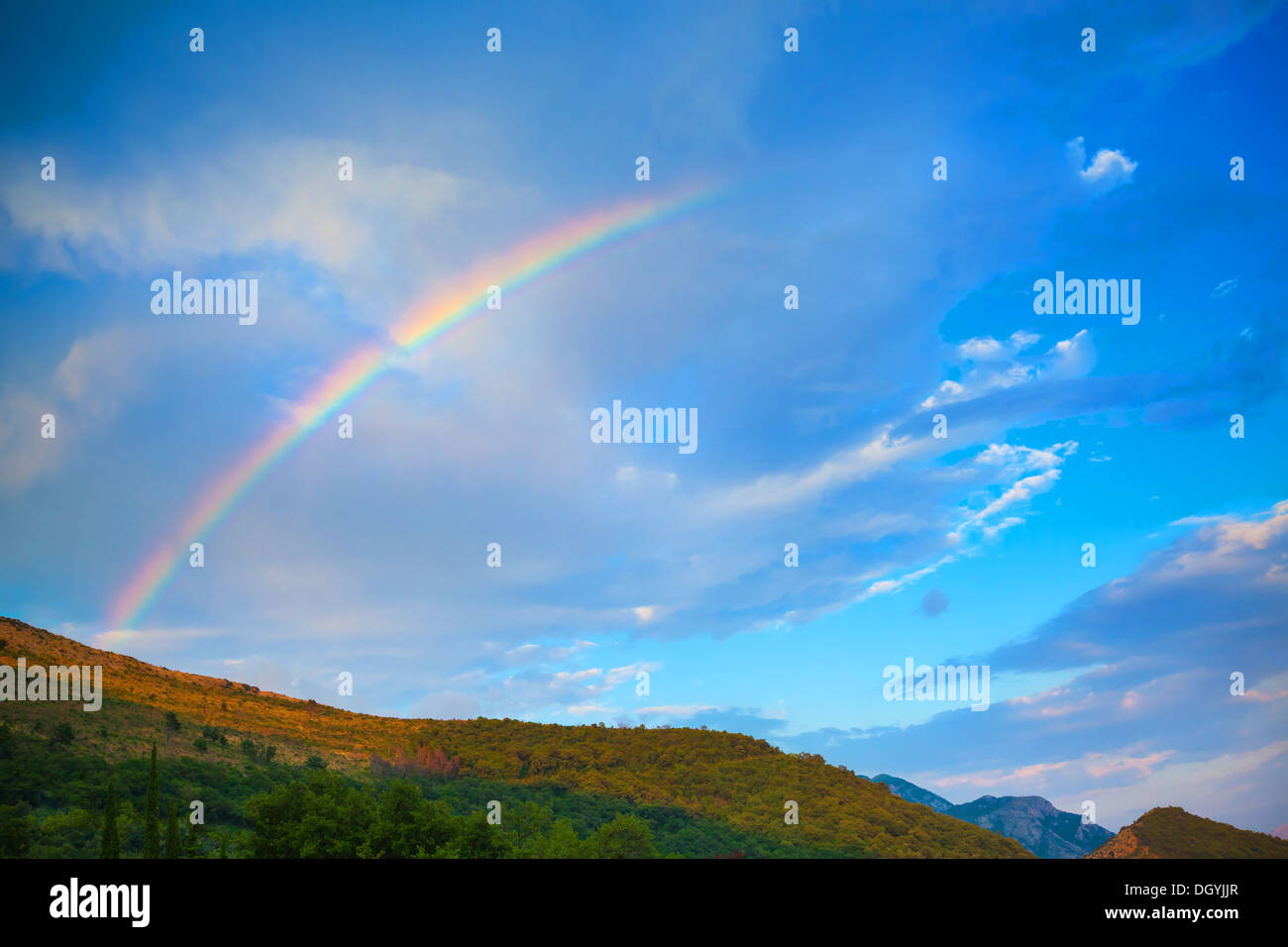 Natura della montagna dello sfondo della foto con un luminoso arcobaleno nel drammatico cielo nuvoloso Foto Stock