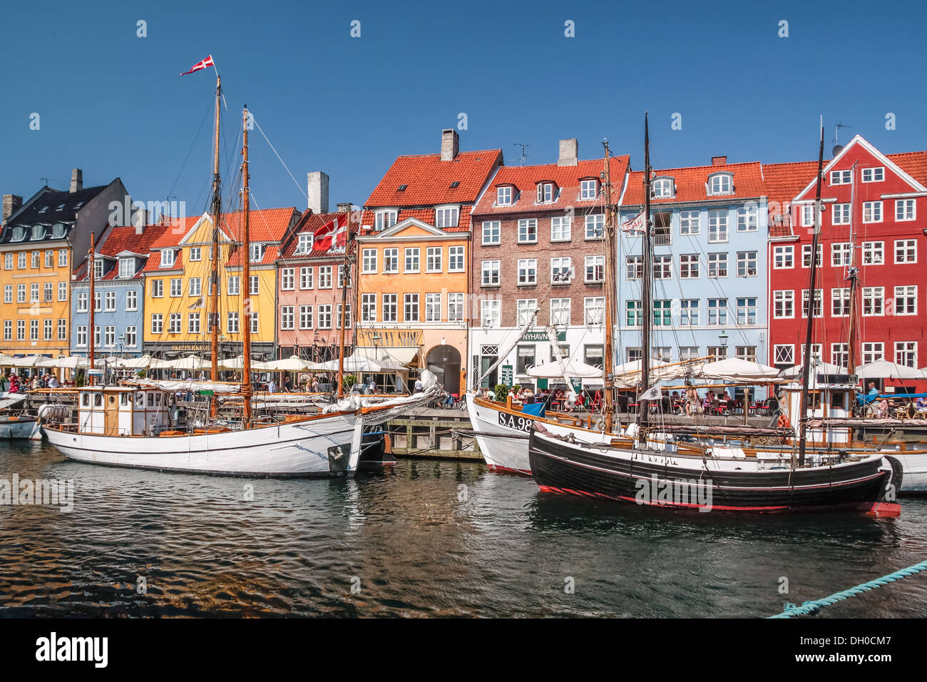 Vecchie barche e case colorate di Nyhavn a Copenaghen, Danimarca Foto Stock