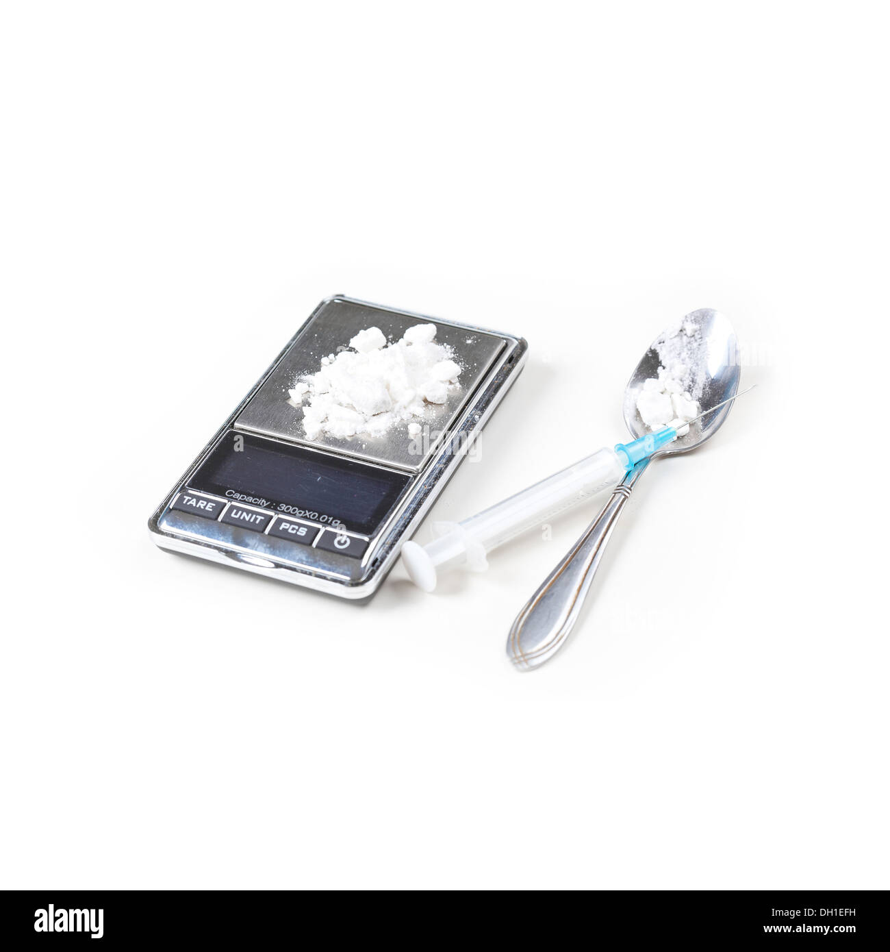 La siringa e la bilancia digitale con farmaci closeup su bianco Foto Stock