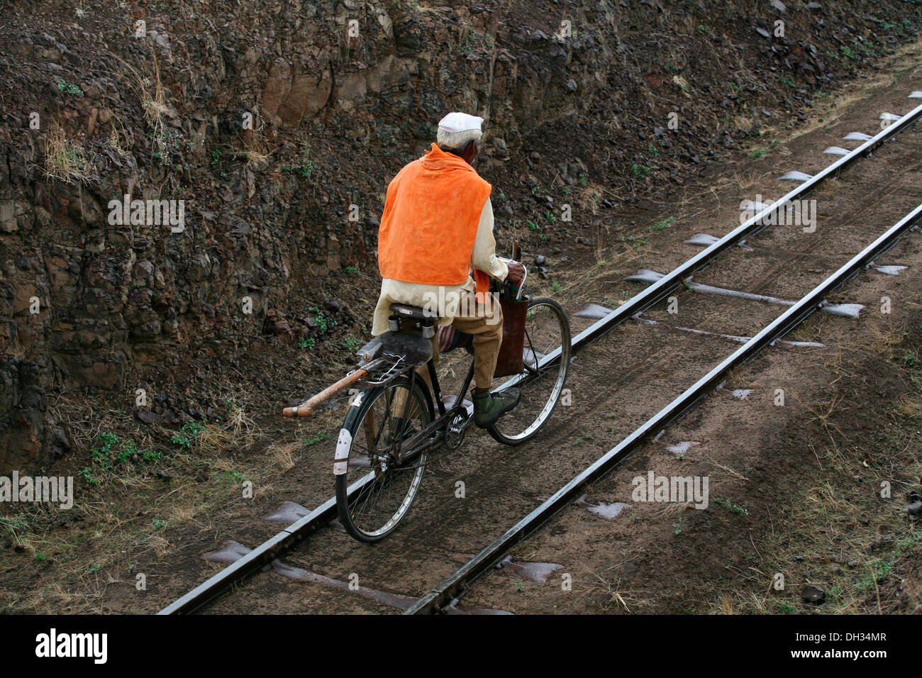 Uomo a cavallo in bicicletta sul binario ferroviario Miraj Maharashtra India Asia Foto Stock