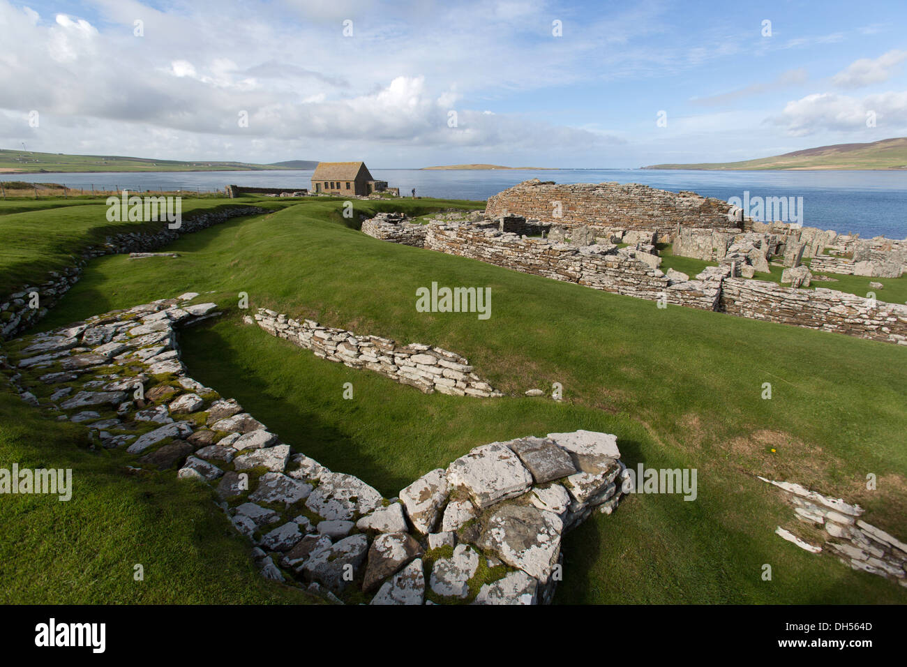 Isole di Orkney, Scozia. Vista pittoresca del broch village at Gurness, con Eynhallow suono in background. Foto Stock