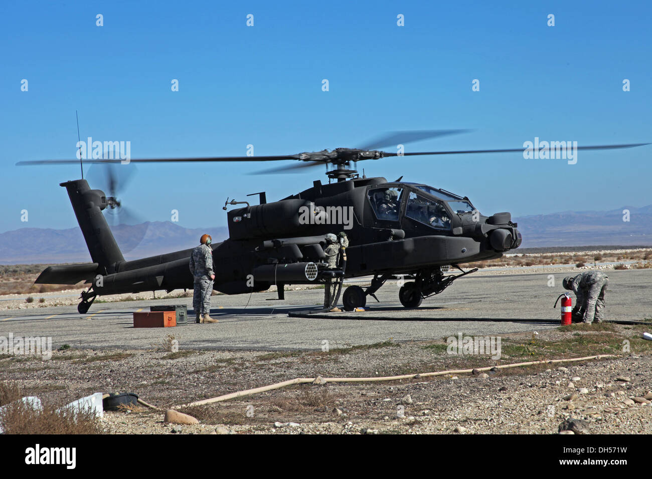 I soldati della 2-158th elicottero d'assalto battaglione di fare rifornimento di carburante un AH-64E Apache in corrispondenza di una attivazione di avanzamento e punto di rifornimento al Ochard Area Formazione in Idaho ott. 22 a sostegno di varie azioni di formazione. La formazione è stata parte della Task Force High-Altitu Warhawk Foto Stock