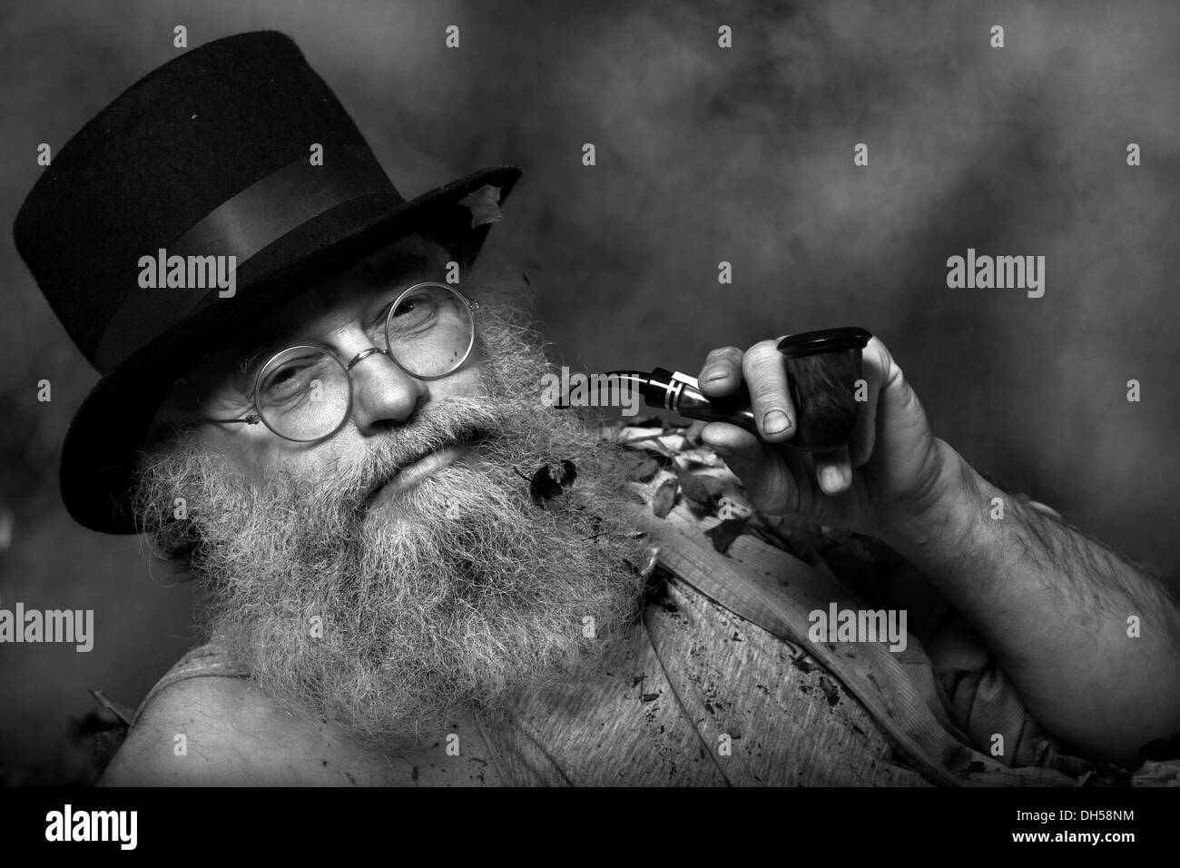 Uomo anziano con una lunga barba che indossa un cappello a cilindro e  bicchieri, fumare una tubazione, Reith im Alpbachtal, Distretto di  Kufstein, Tirolo del Nord Foto stock - Alamy