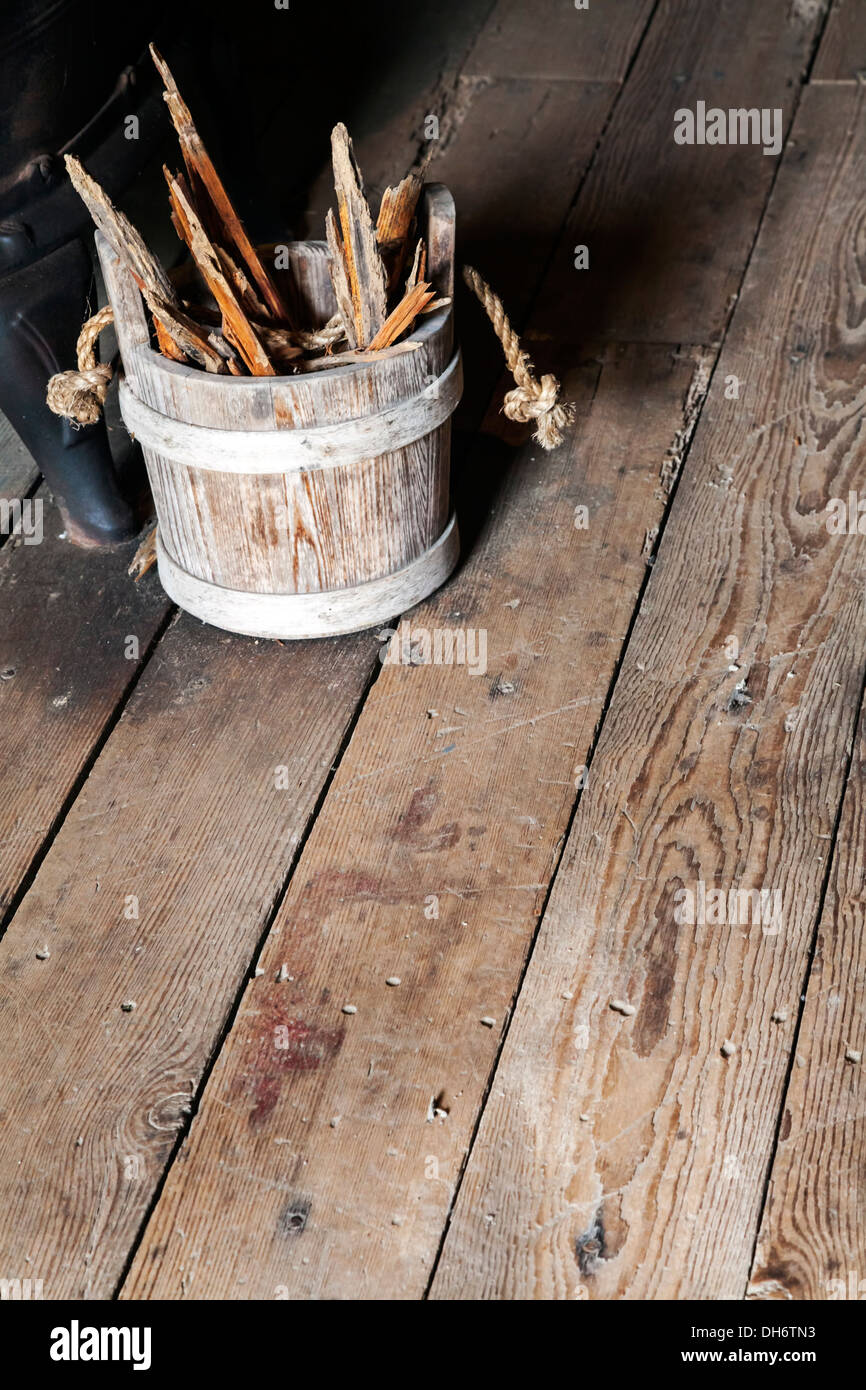 Il vecchio secchio di legno con un manico di corda riempite con pezzi di legno seduto accanto a una pentola pance stufa. Newberry, Florida USA Foto Stock