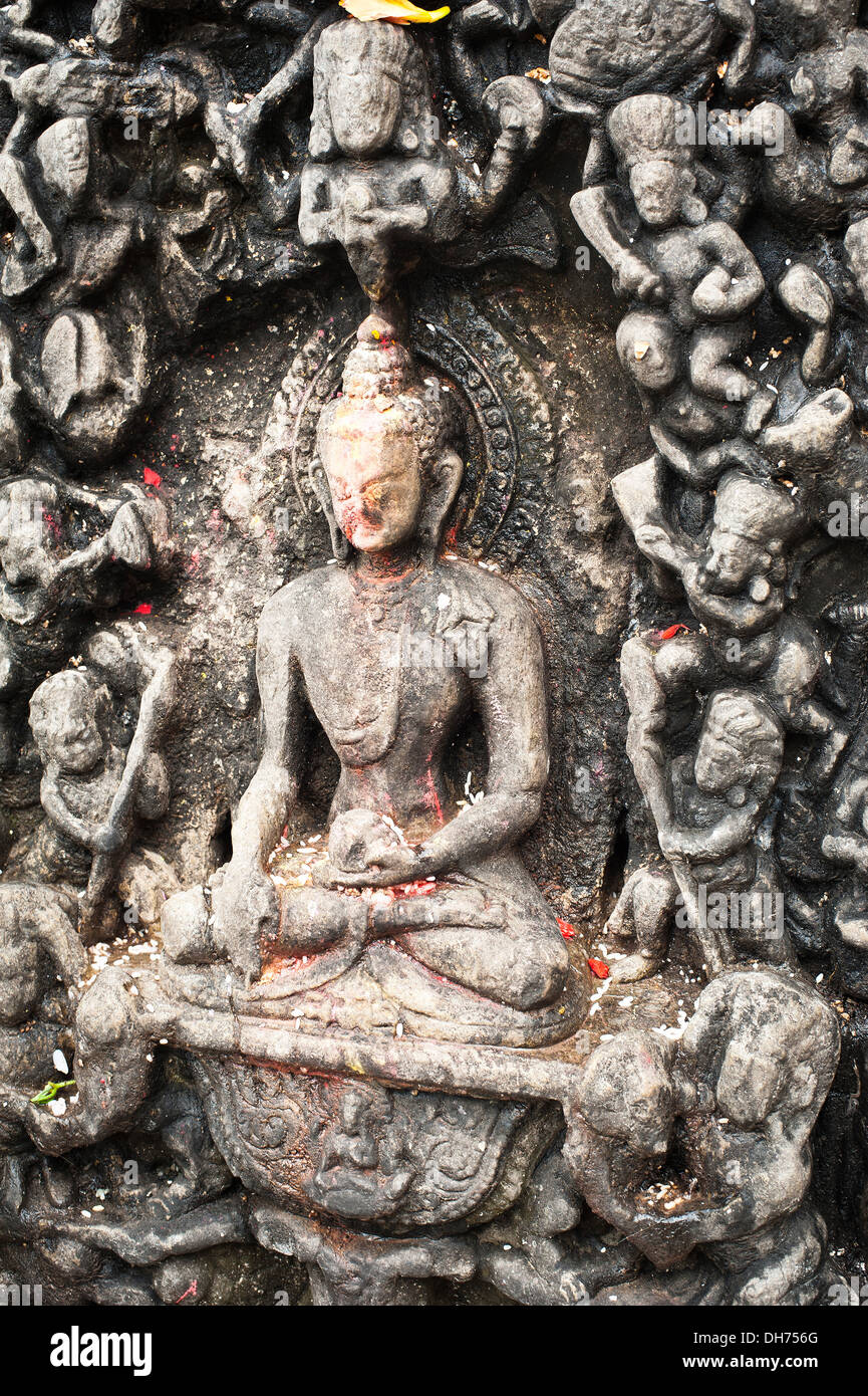 La scultura in pietra di meditazione Buddha con offerte al santuario buddista di Swayambhunath Stupa. Monkey Temple Nepal, Kathmandu Foto Stock