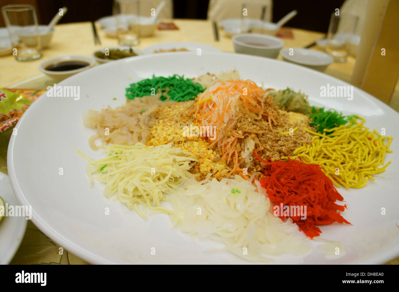 Yee sang o prosperità toss, con insalata di pesce crudo, per celebrare il nuovo anno cinese nei paesi del sud-est asiatico Foto Stock