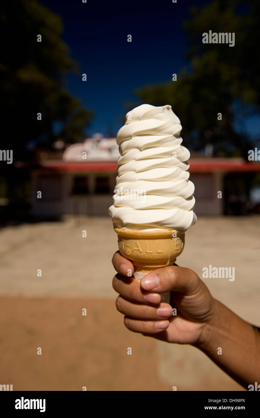 Donna che mantiene un gelato alla vaniglia cono nella parte anteriore di una gelateria a Milwaukee nel Wisconsin. Foto Stock