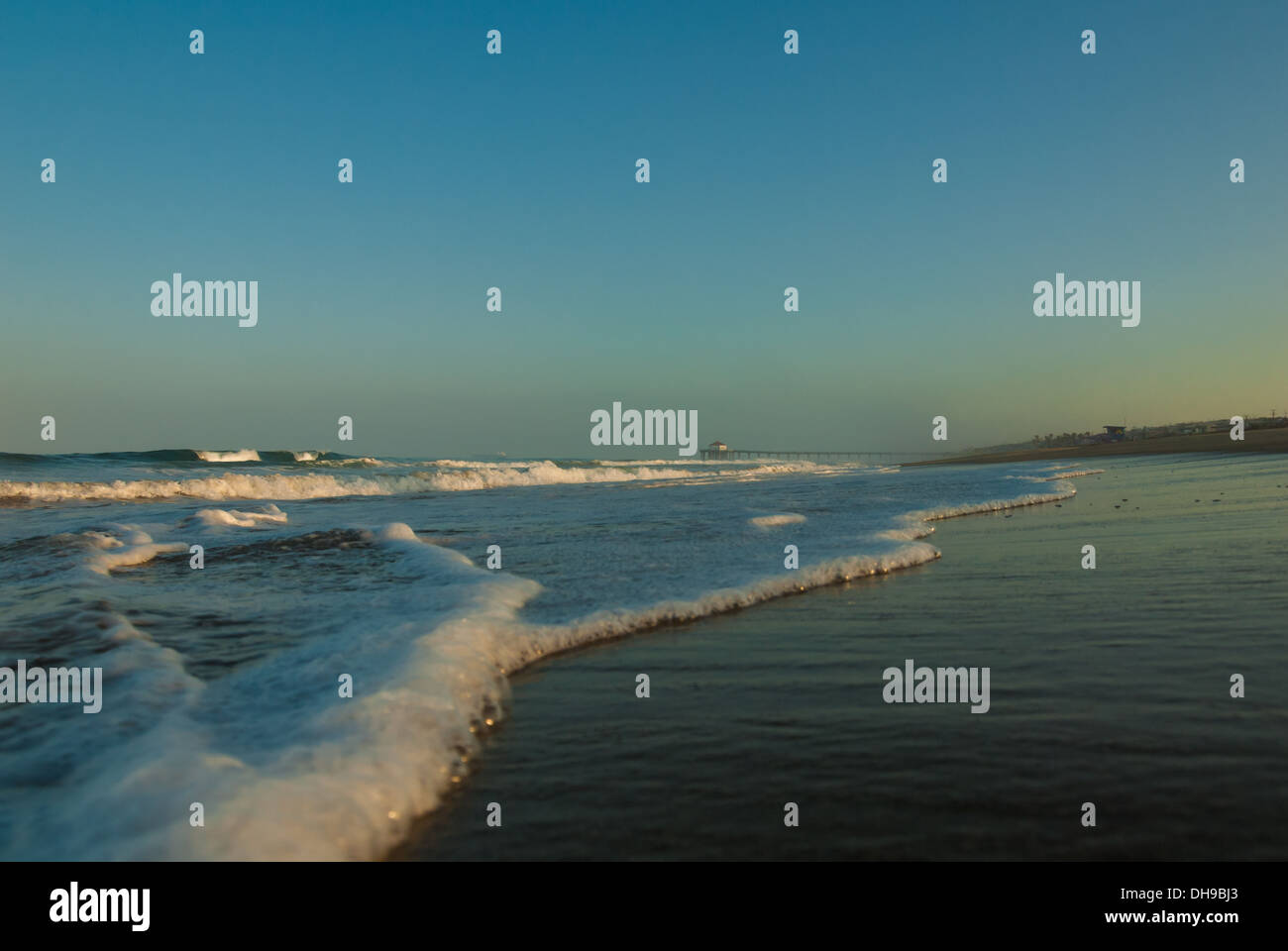 Vista bassa del molo di Manhattan Beach e delle onde in arrivo al primo semaforo del mattino. Manhattan Beach, California. (USA) Foto Stock