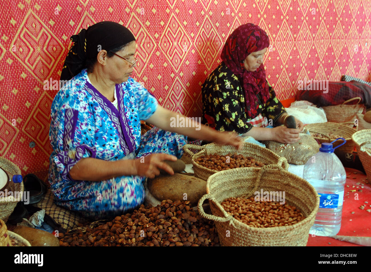 Marocchino donne al lavoro rendendo l'olio di argan. Foto Stock