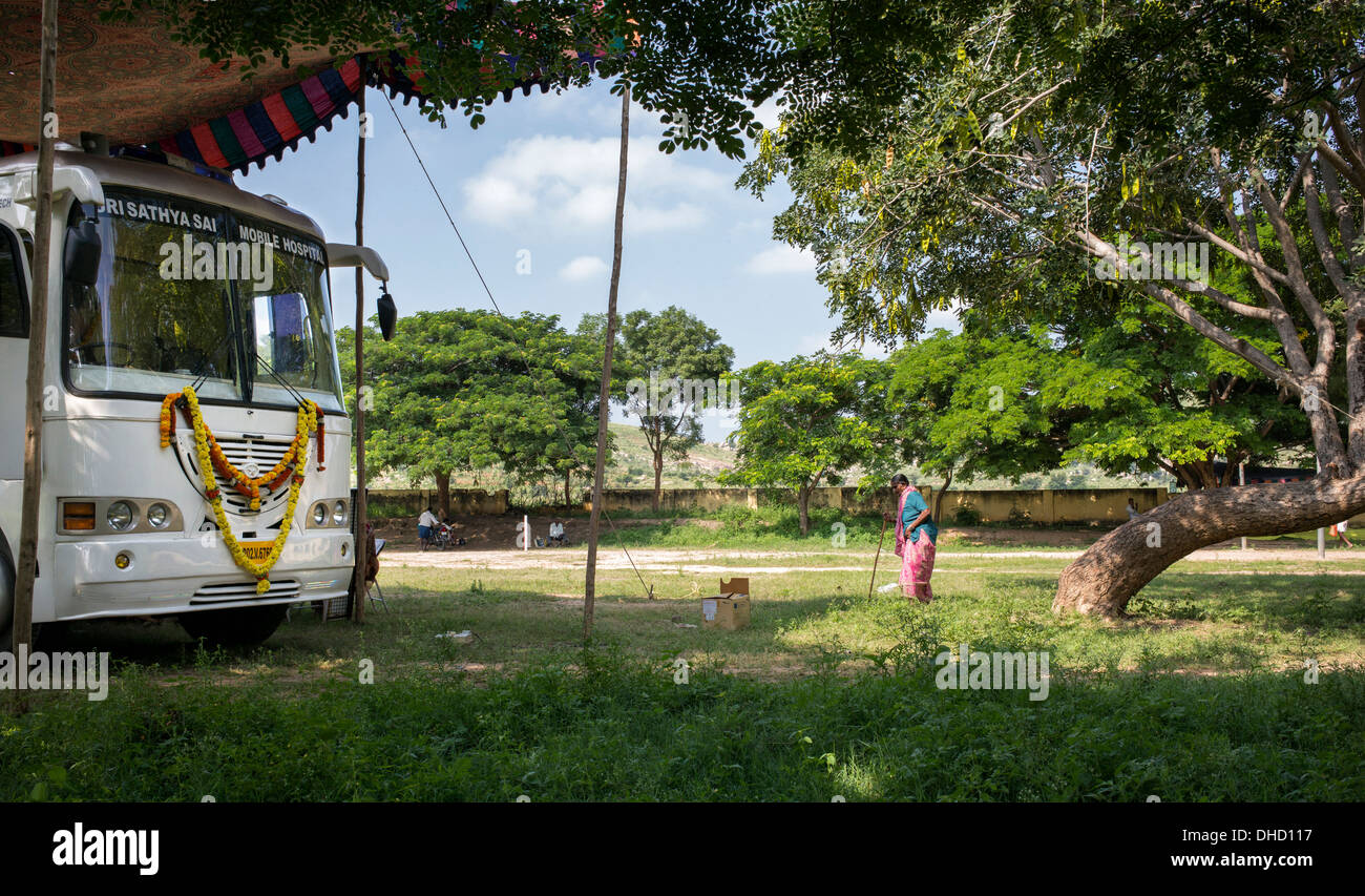 Rurale donna indiana a piedi Sri Sathya Sai Baba mobile outreach bus dell'ospedale. Andhra Pradesh, India Foto Stock