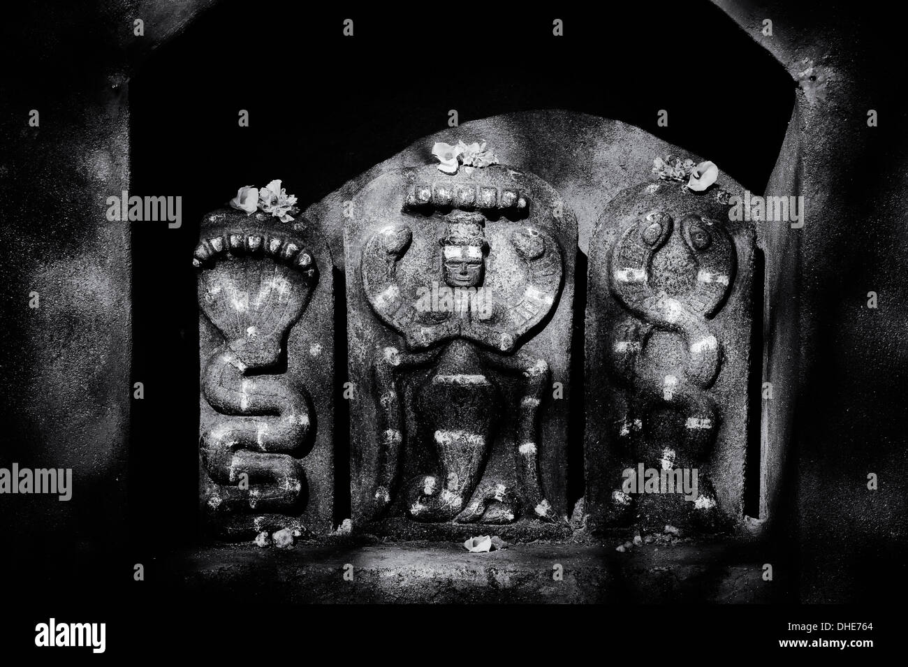 Indù santuario di pietre a un tempio raffigurante Indian vishnu divinità nelle zone rurali del sud villaggio indiano. Andhra Pradesh, India. Monocromatico Foto Stock