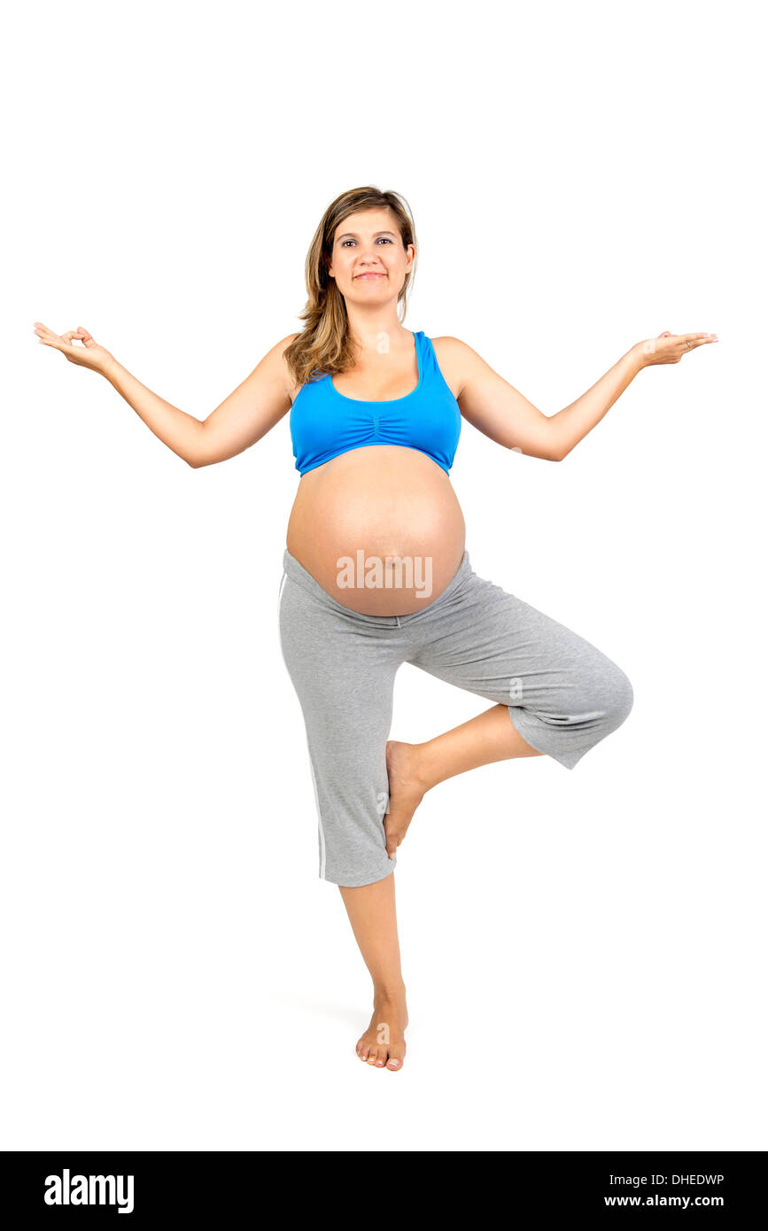 Bella donna incinta in posa di abbigliamento fitness Foto Stock