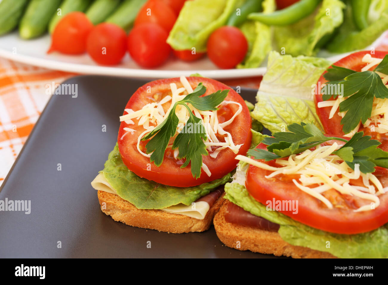 Panini con pancetta, lattuga, pomodoro e formaggio sulla piastra. Foto Stock