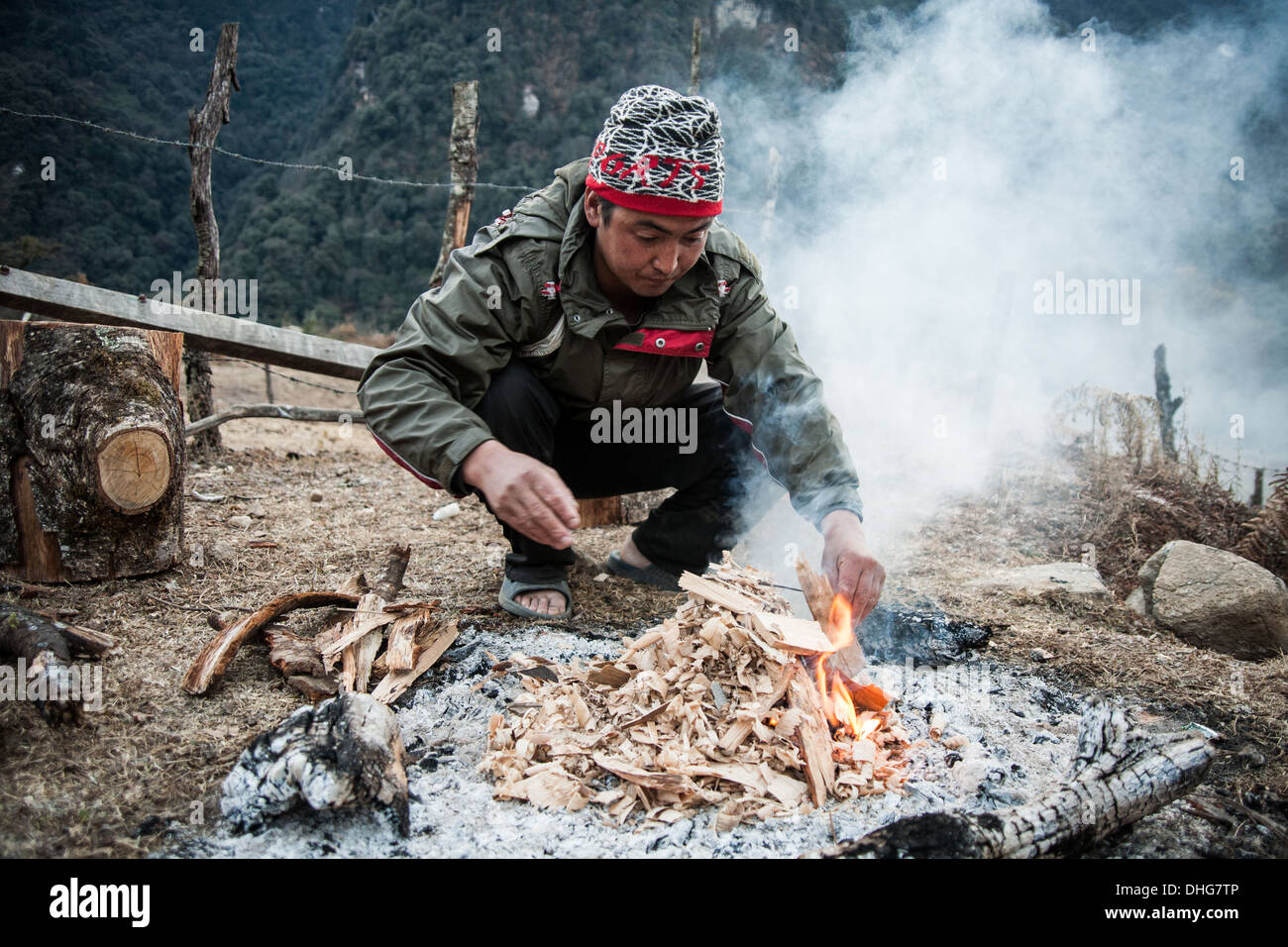 Un camp cook inizia il fuoco su un congelamento gli inverni di notte, Gasa - Himalaya Bhutanese Foto Stock