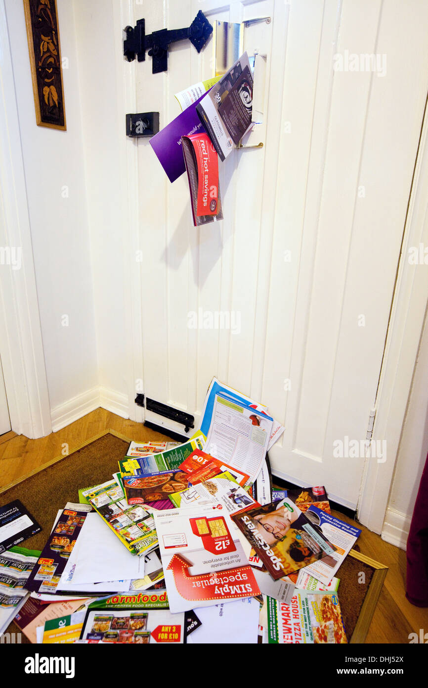 La posta indesiderata è inviato attraverso il letterbox e sullo zerbino di casa, England Regno Unito Foto Stock