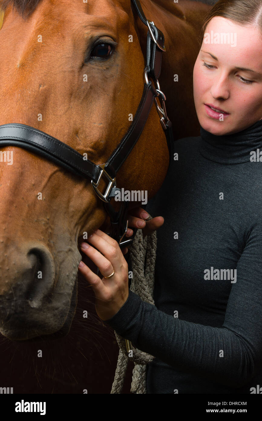 Donna e cavallo insieme, donna guarda verso il cavallo Foto Stock