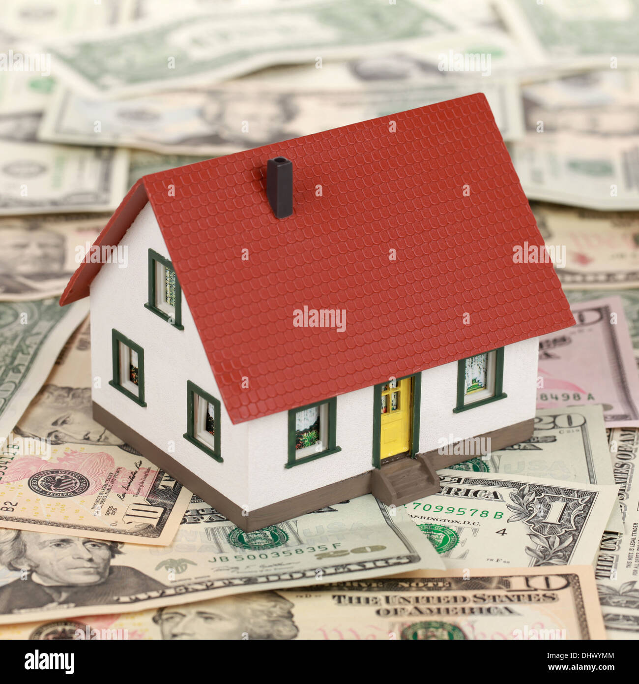 Un finanziamento immobiliare con un modello di casa sul dollaro banconote Foto Stock