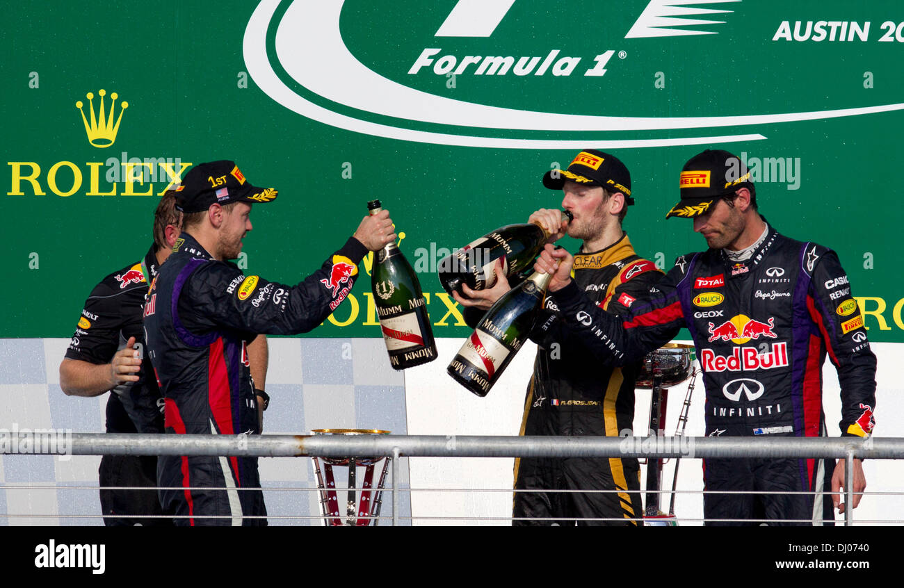 Piloti Sebastian Vettel (l), Romain Grosjean e Mark Webber (r) gustare champagne dopo la finitura 1-2-3 negli Stati Uniti Il Grand Prix al circuito delle Americhe Foto Stock