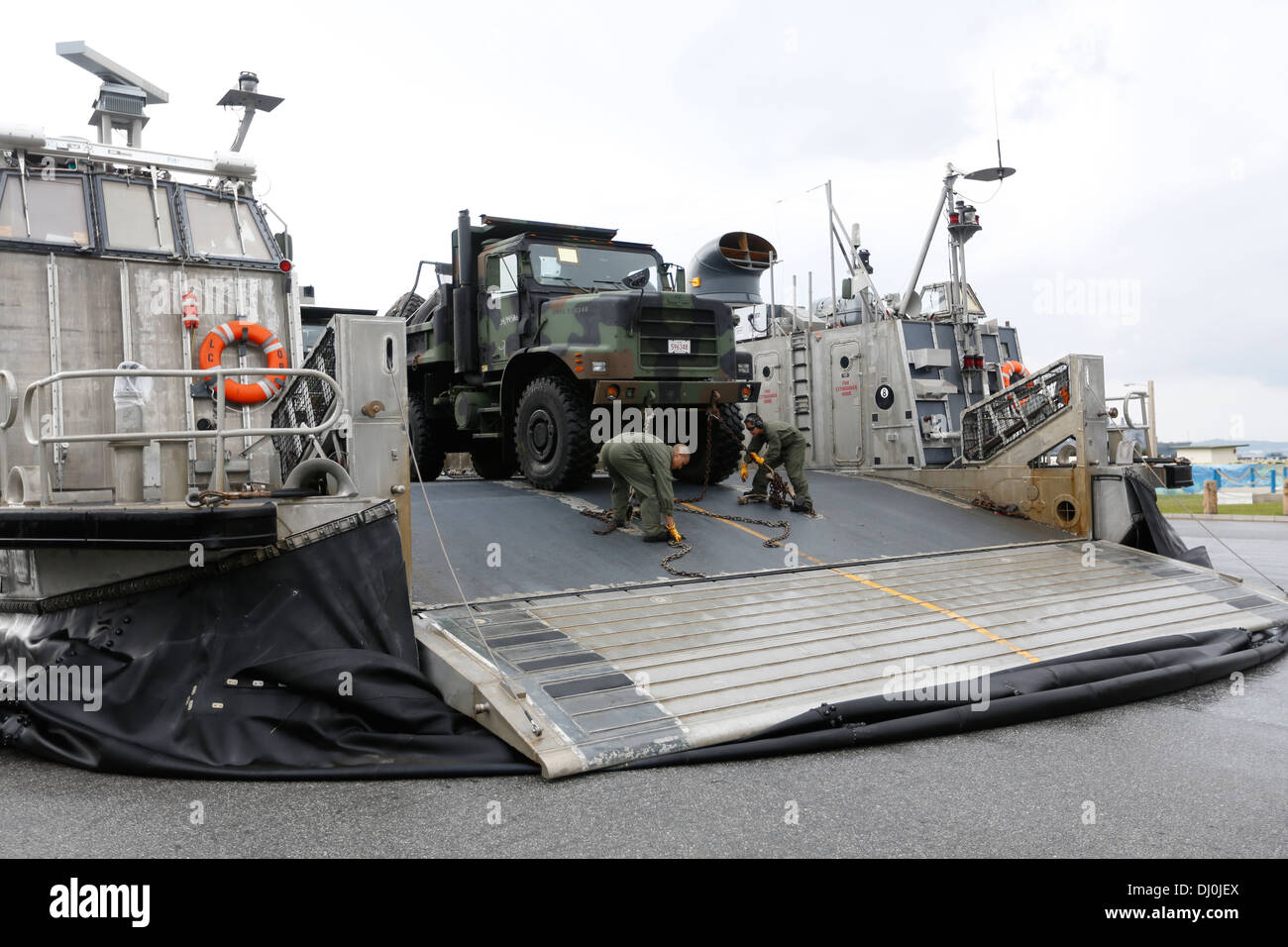 Stati Uniti I marinai con il trentunesimo Marine Expeditionary Unit, III Marine forza expeditionary, la catena verso il basso i veicoli e le attrezzature su una Landing Craft Air Cushion a U.S. Navy Spiaggia Bianca impianto portuale, Okinawa, in Giappone, nov. 16, 2013. I marines e marinai caricato Foto Stock