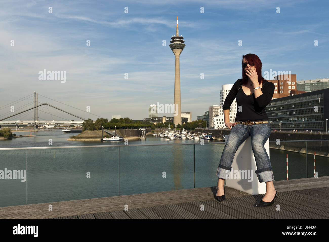 La ragazza si siede a Düsseldorf Mediahafen Foto Stock