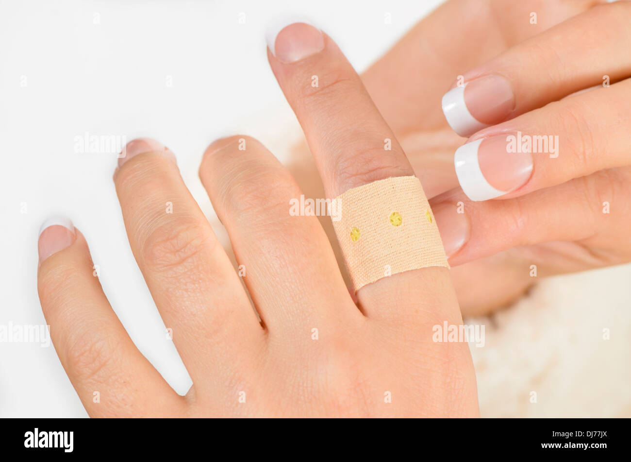 Persona di mettere un cerotto sul dito isolati su sfondo bianco Foto stock  - Alamy