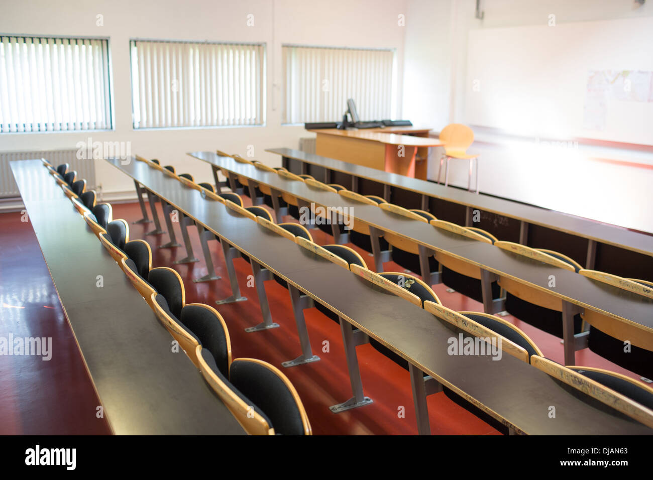 Sedi vuote con tabelle in un aula magna Foto Stock