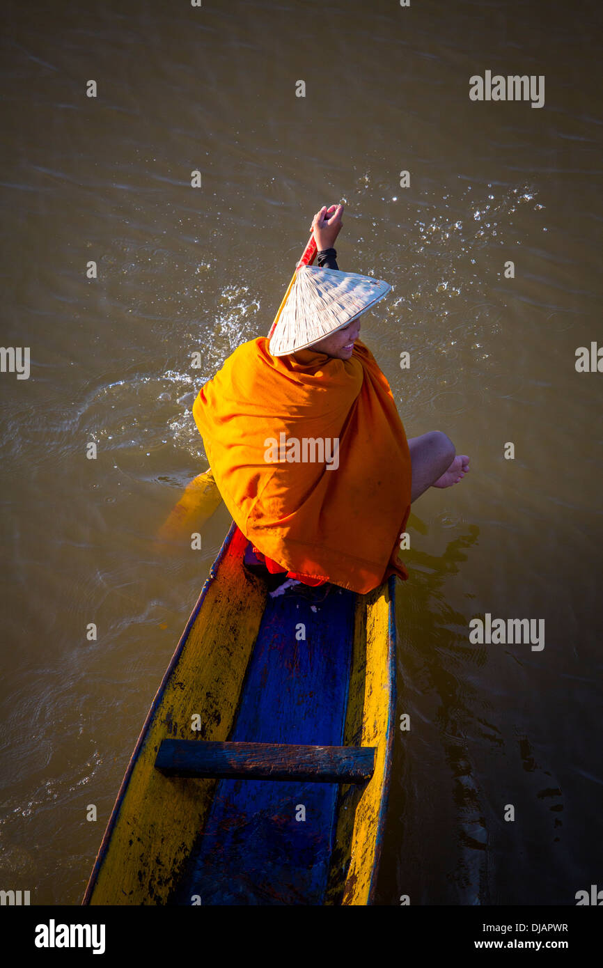 I monaci buddisti su una barca a remi sul fiume Mekong in Paske, Laos Foto Stock