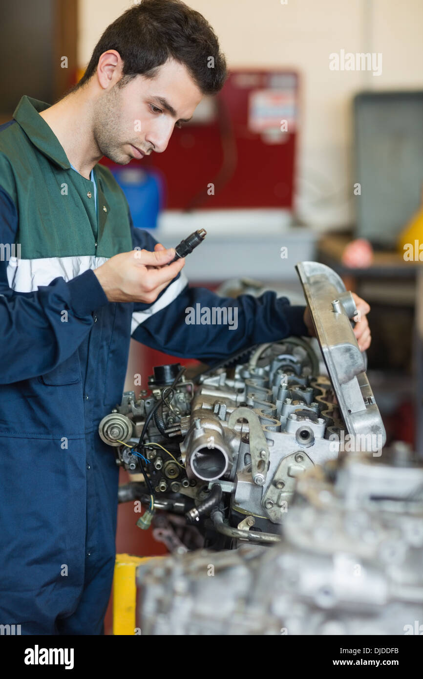 Focalizzato repairman la riparazione di un motore Foto Stock