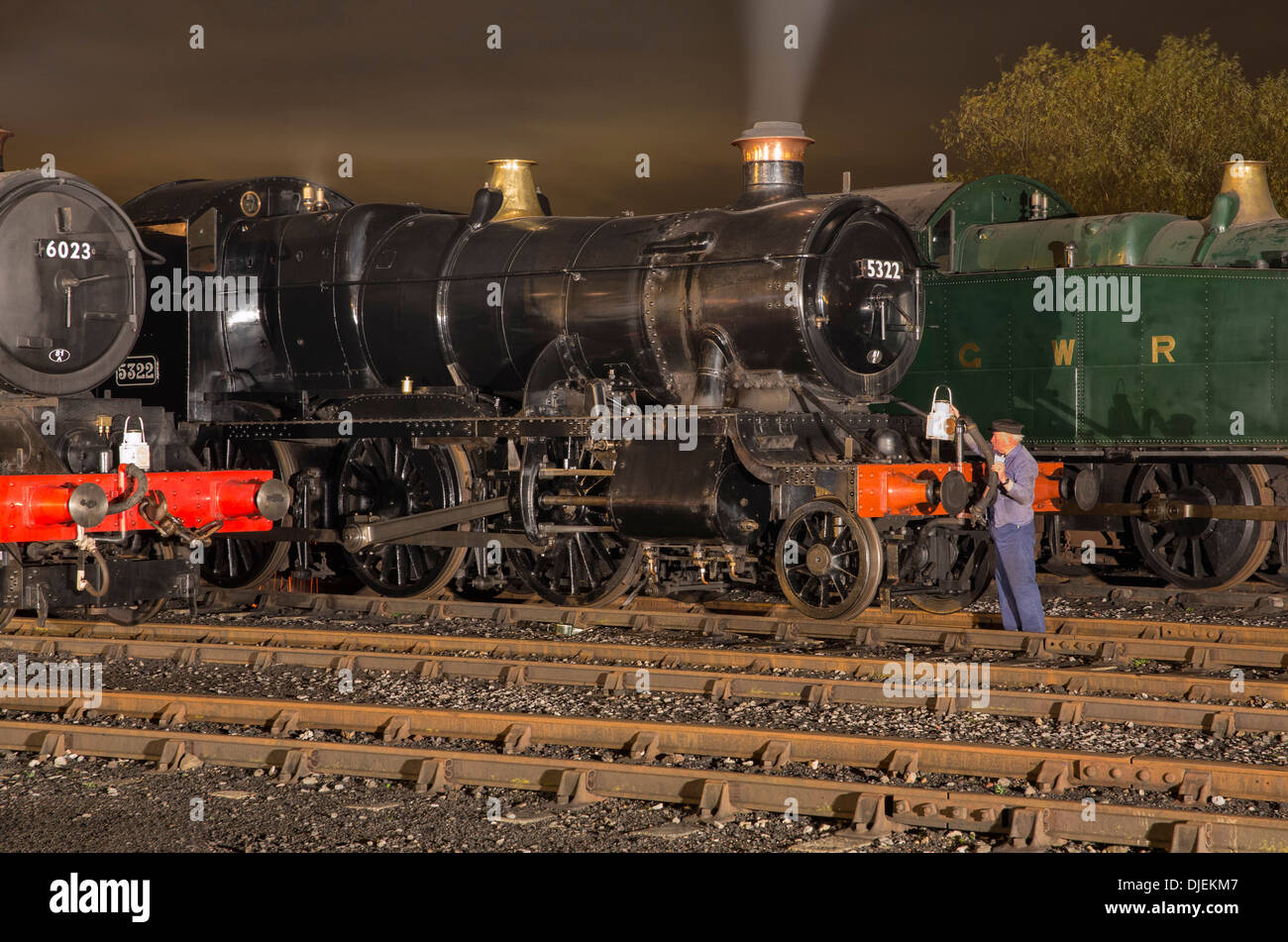 GWR conserve di locomotive a vapore 6023 'King Edward II', 43xx classe 2-6-0 5322 & Collett Classe 5600 0-6-2T 6697 su un capannone di notte Foto Stock