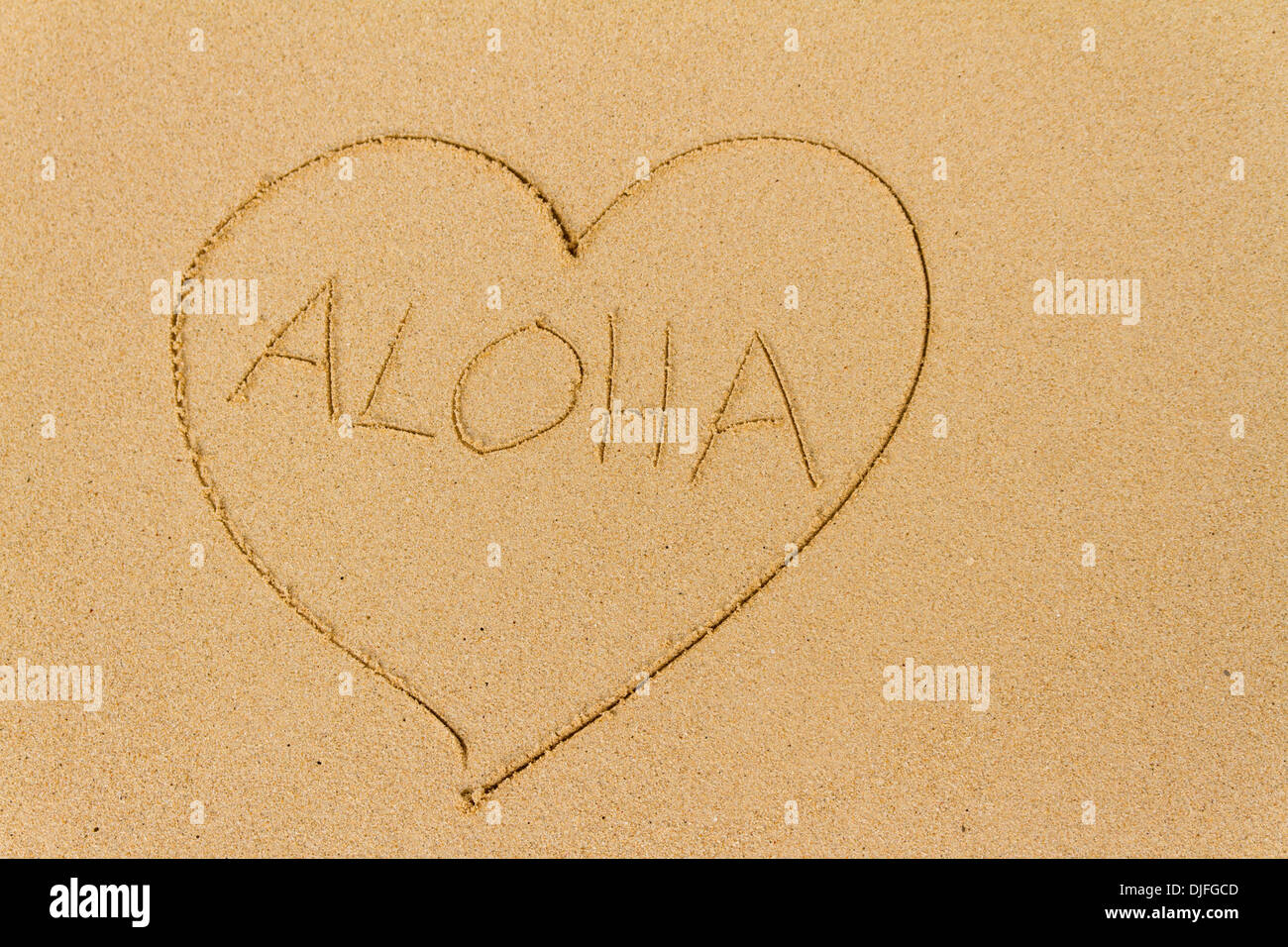 Un cuore disegnato nella sabbia con la parola Aloha; Honolulu Oahu, Hawaii, Stati Uniti d'America Foto Stock