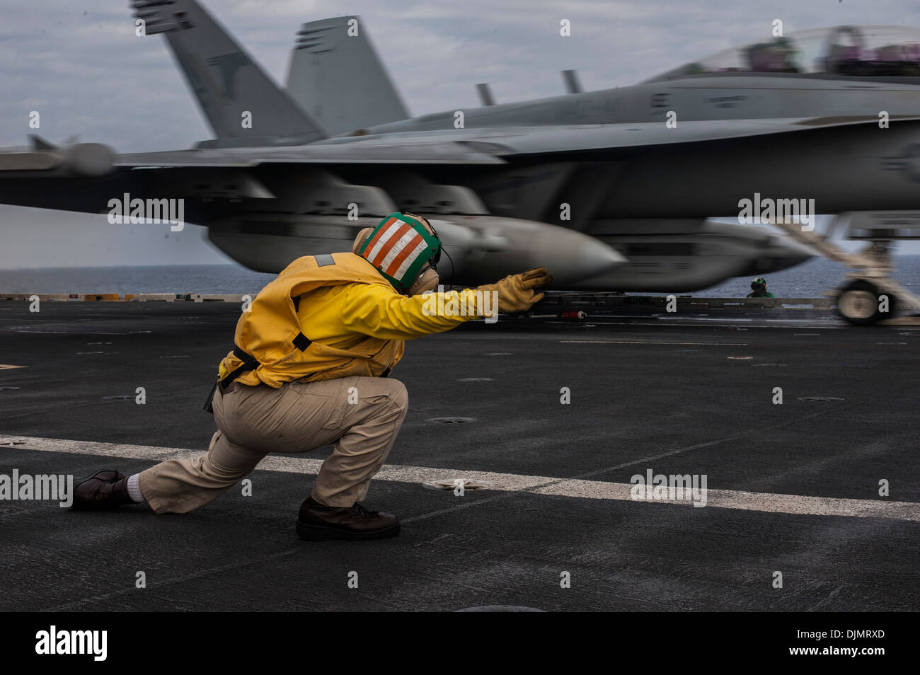 Lt. La Cmdr. Ronald Drake dà il segnale per lanciare un messaggio E/A-18G Growler dal Shadowhawks di Attacco Elettronico Squadron (VAQ) 141 a bordo della portaerei USS George Washington (CVN 73) durante l'esercizio annuale (AE) 13. AE13 è progettato per aumentare la d Foto Stock