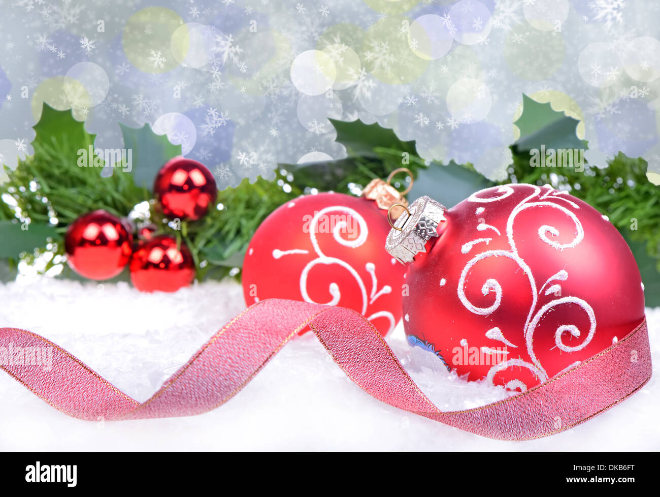 Sfondo di natale con palline rosse e holly foglie e bacche Foto Stock