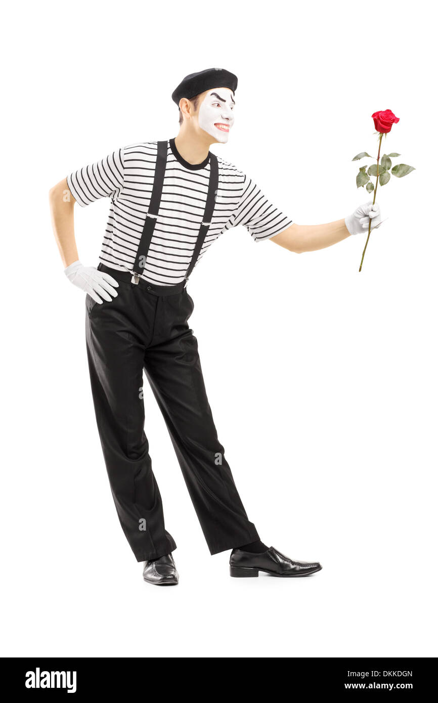 A piena lunghezza Ritratto di un maschio di artista mime dando un fiore rosa Foto Stock